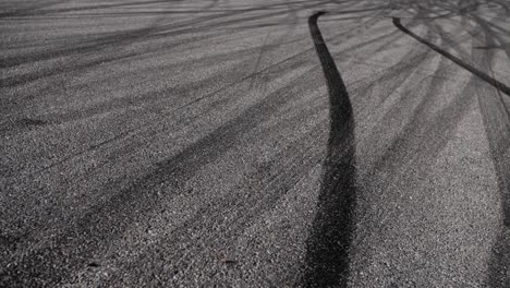 Drift-marks-on-an-asphalt-from-drift-tires,-slow-motion-fly-by