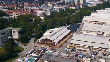 Unbelievable-aerial-top-view-flight-Theresienwiese-october-festival,-sunny-day-before-opening