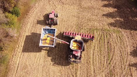 harvesting corn using combine harvester in southeast michigan - aerial top down