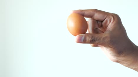 men holding a egg against white background