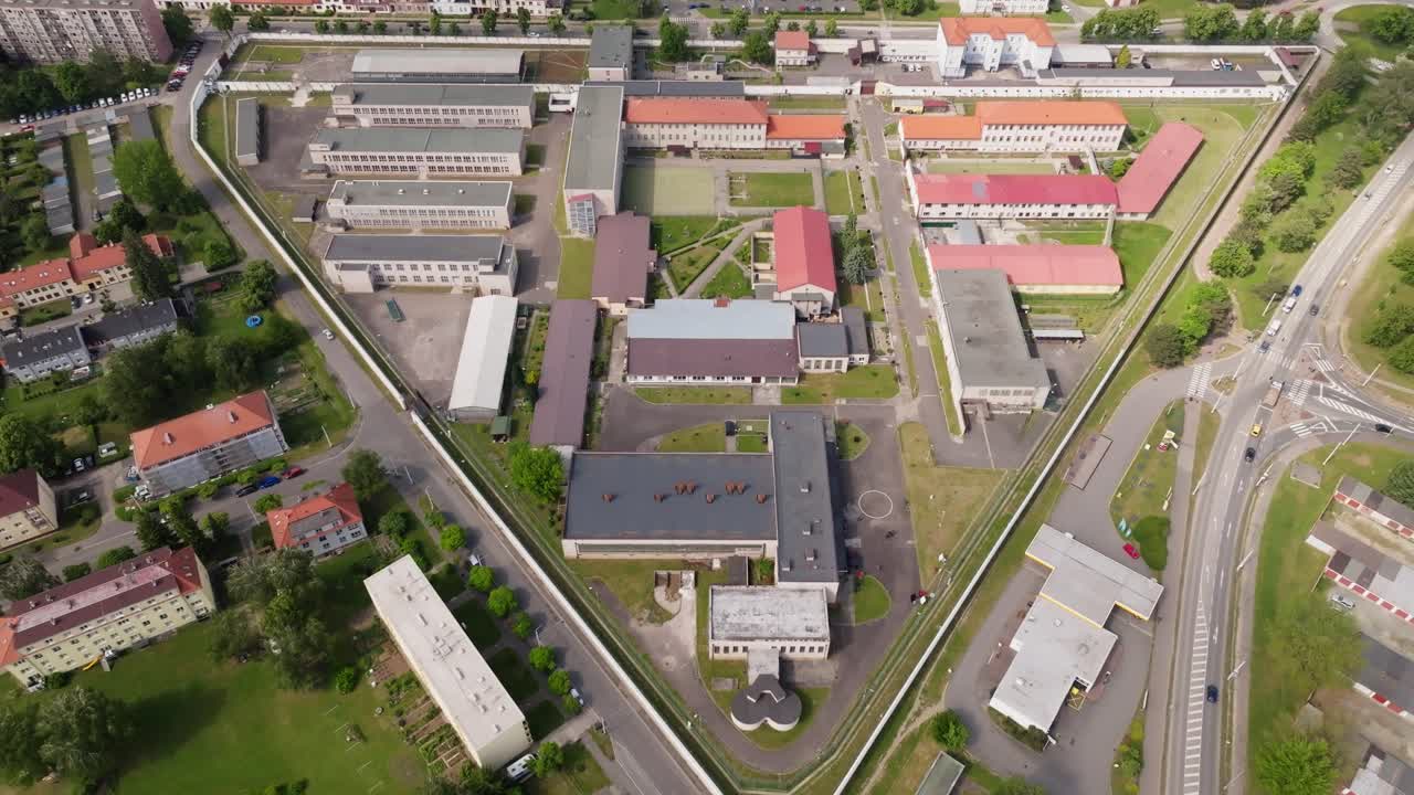 Stable aerial hover near guard tower with gentle yaw for exterior detail; continuous shot, daytime