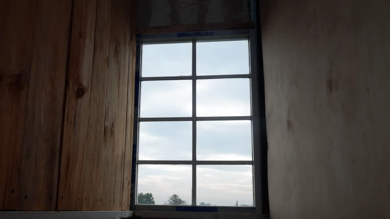 Tidsforkortet optagelse af morgenhimmel gennem et vindue