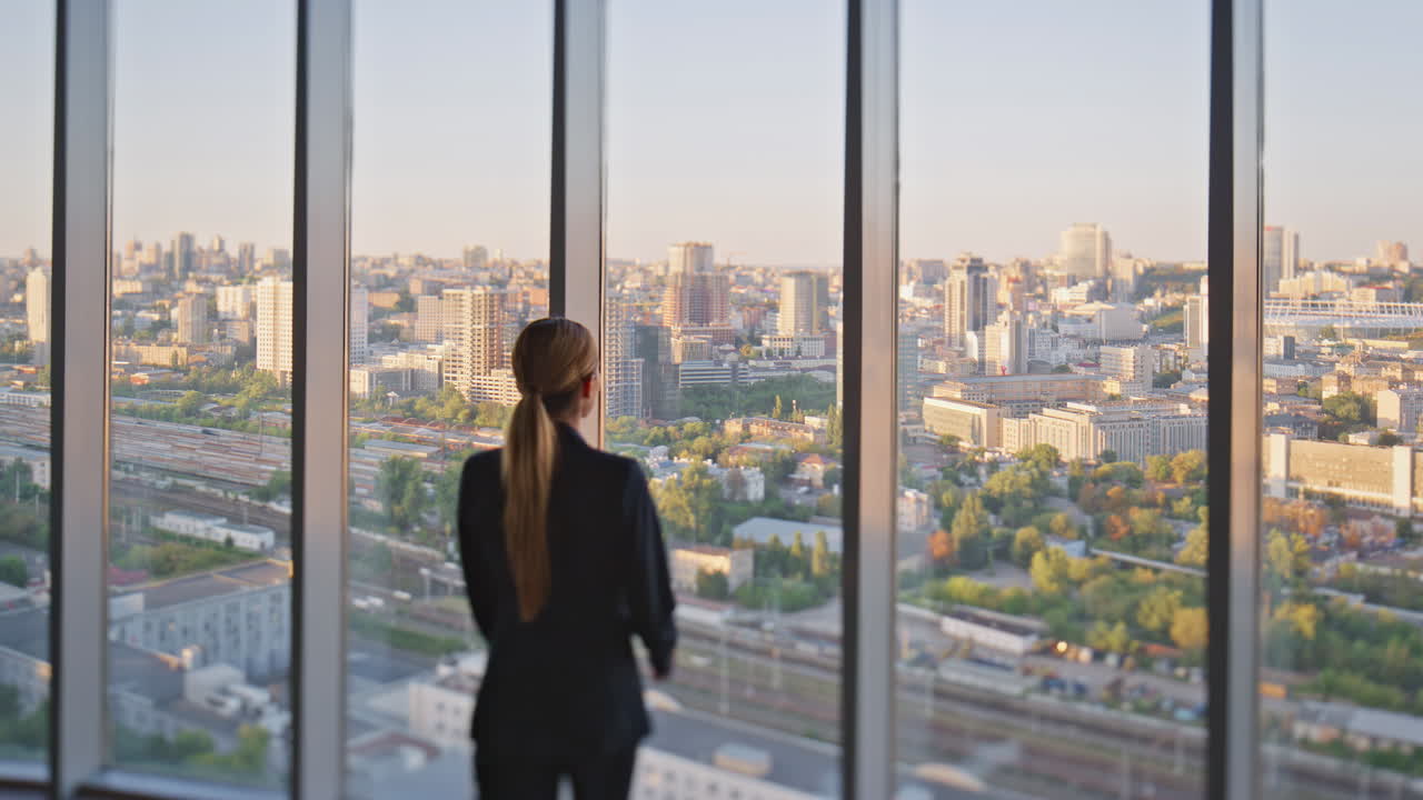 mujer de negocios disfrutando de la vista de la ciudad en la oficina.