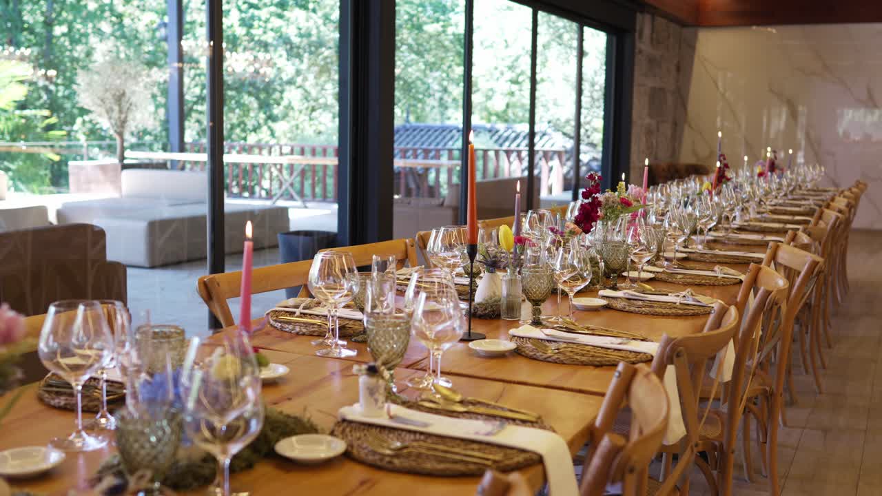 Long wedding table with candles flowers and glasses indoors location irrelevant
