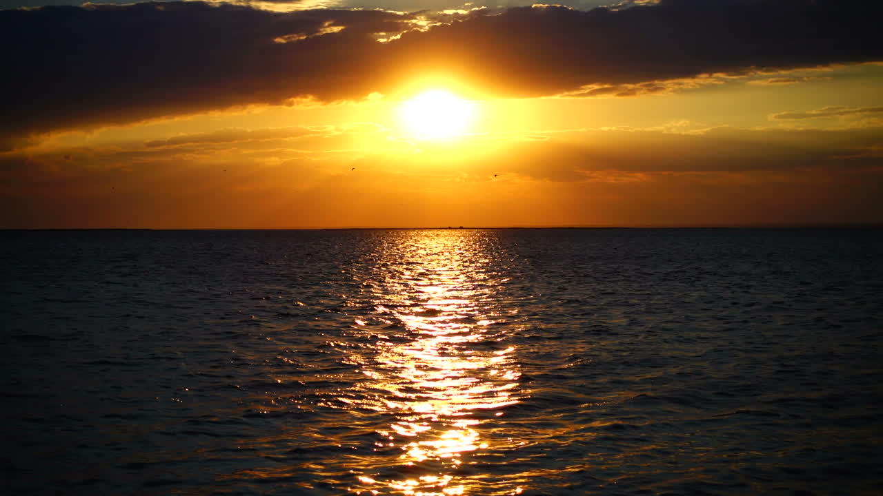 Sunset over the sea. Slow motion. Shooting at the sea
