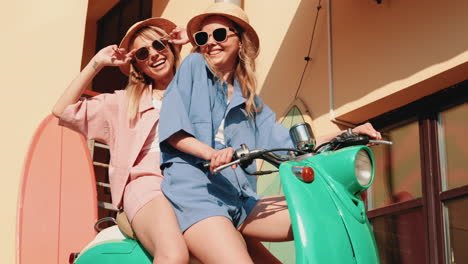 two women riding a scooter on vacation