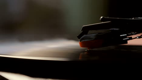 close-up of using an antiquarian vinyl record player. turntable player,dropping stylus needle on vinyl record playing