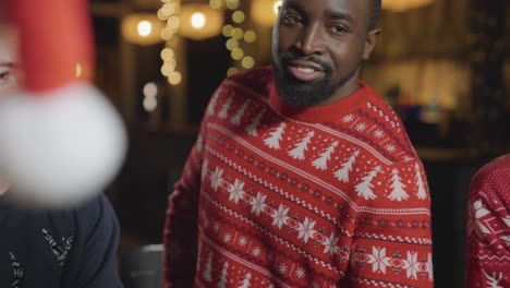 Tracking-Shot-Around-Group-of-Friends-Celebrating-Christmas-at-a-Bar