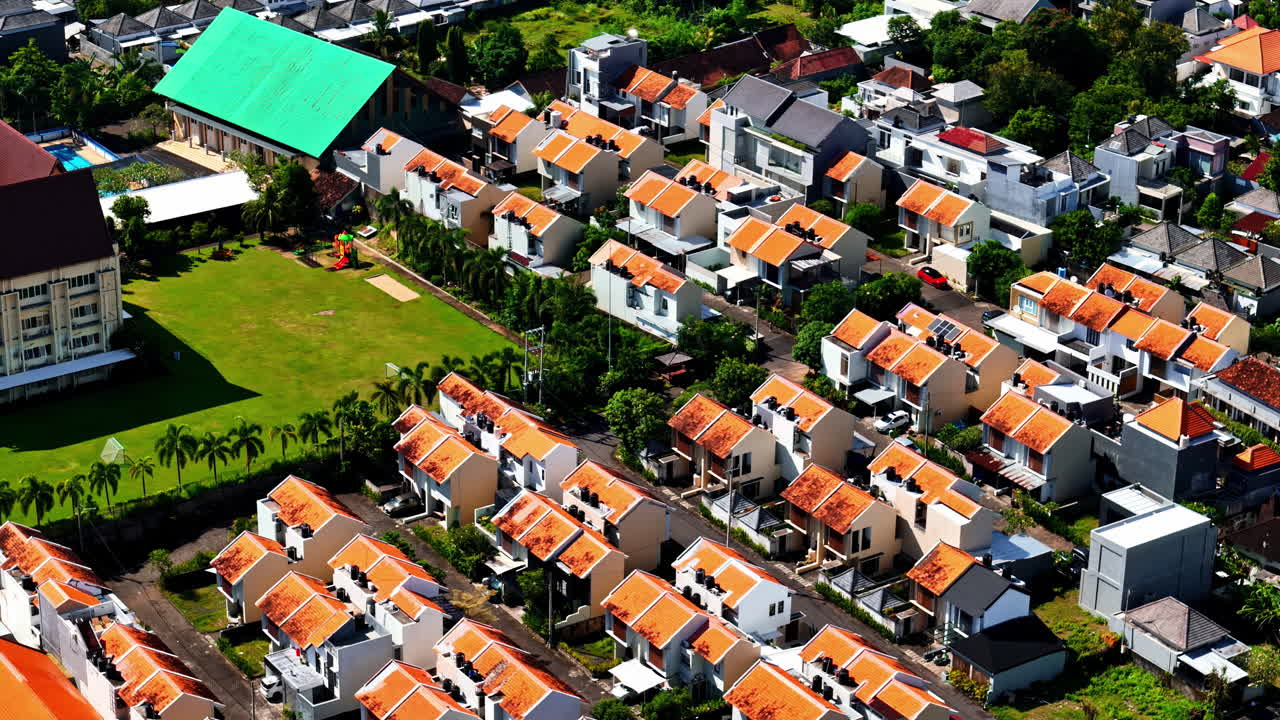 Sunlit red roof houses of Kuta Selatan Bali, showcasing a uniform and vibrant neighborhood