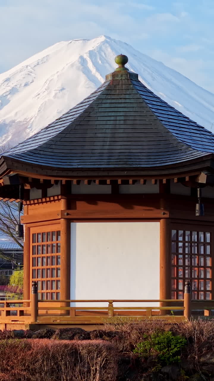 Aerial drone view of a temple with Mount Fuji on the background in Fujikawaguchiko, Japan