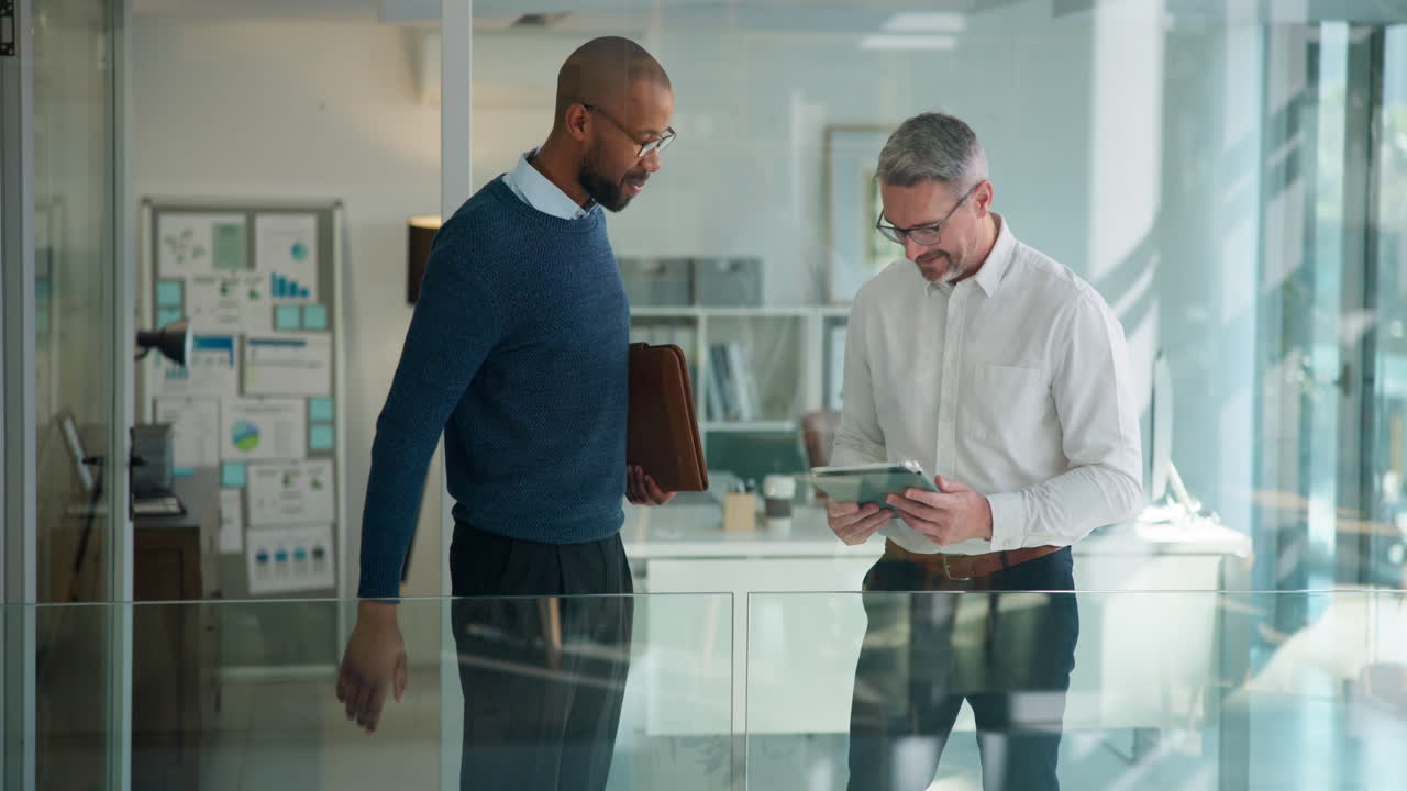 Two Businessmen Shake Hands and Discuss Project on Tablet in Modern Office