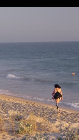 woman with prosthetics walking on the beach