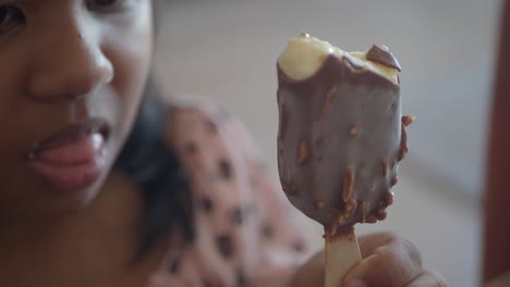 child eating chocolate ice cream