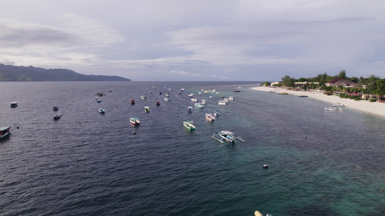 Aerial view over moored boats in Gili Trawangan, golden hour in Indonesia