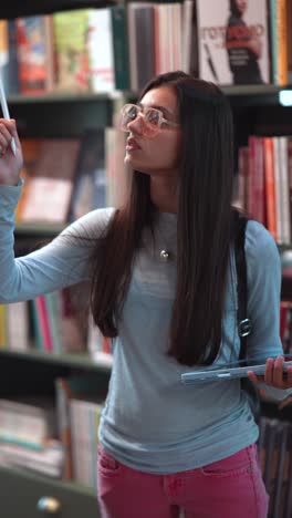 student in library with tablet