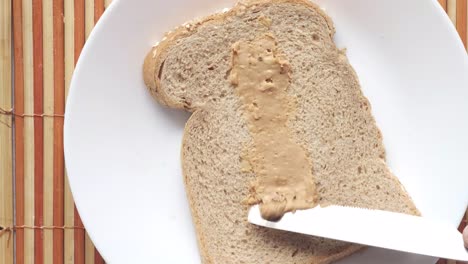 making a peanut butter sandwich on whole wheat bread