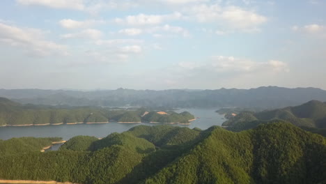 forest peaks rise above water surface in man-made xinanjiang reservoir