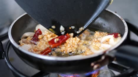 putting onion on vegetable oil into frying pan