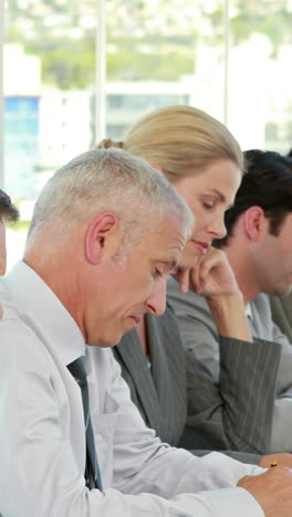 business team taking notes during conference