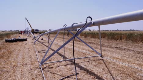 wide shot of center pivot irrigation system in a summer day in pakistan