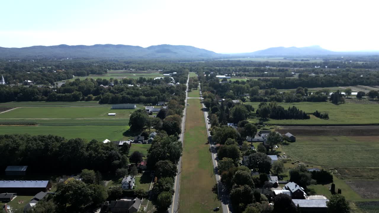 Aerial view of rural Hadley town with local oval road in residential area and hills, Massachusetts, USA