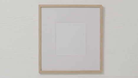 wooden frame with copy space against white wall