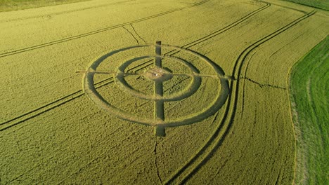 hackpen hill strange wheat field target crop circle design in green farmland aerial view orbiting right