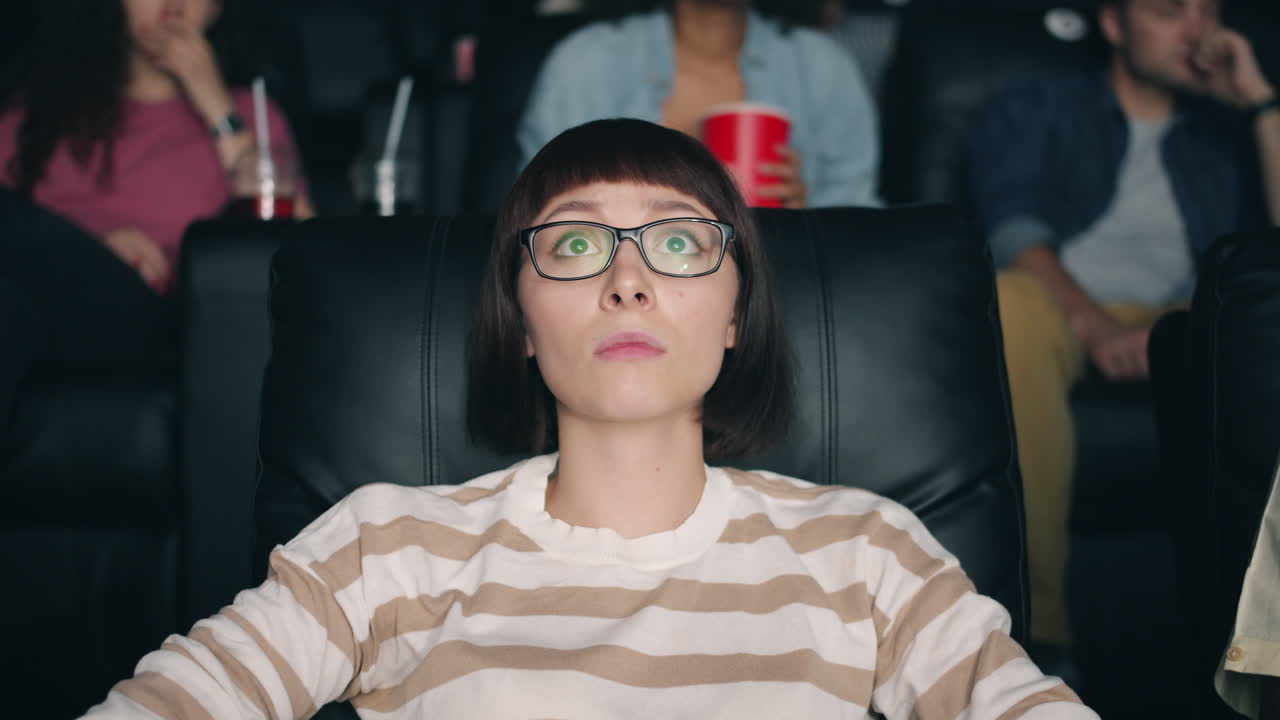 Woman Watching a Movie in a Theater