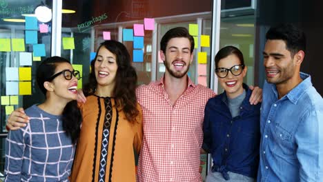 ejecutivos sonrientes de pie con los brazos alrededor