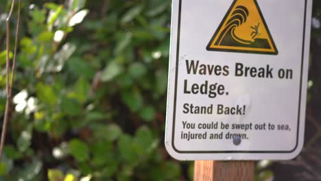 waves break sign to warn beachgoers