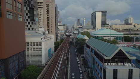 elevated train tracks and train station next to hotel