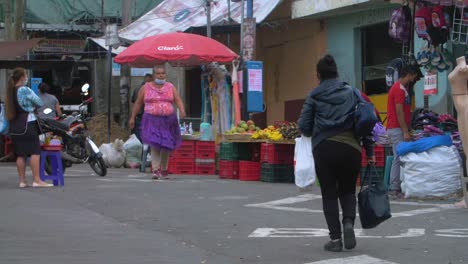 people shopping at a street market in central america
