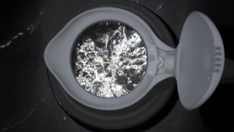 boiling water bubbles comes up in silicone kettle closeup view