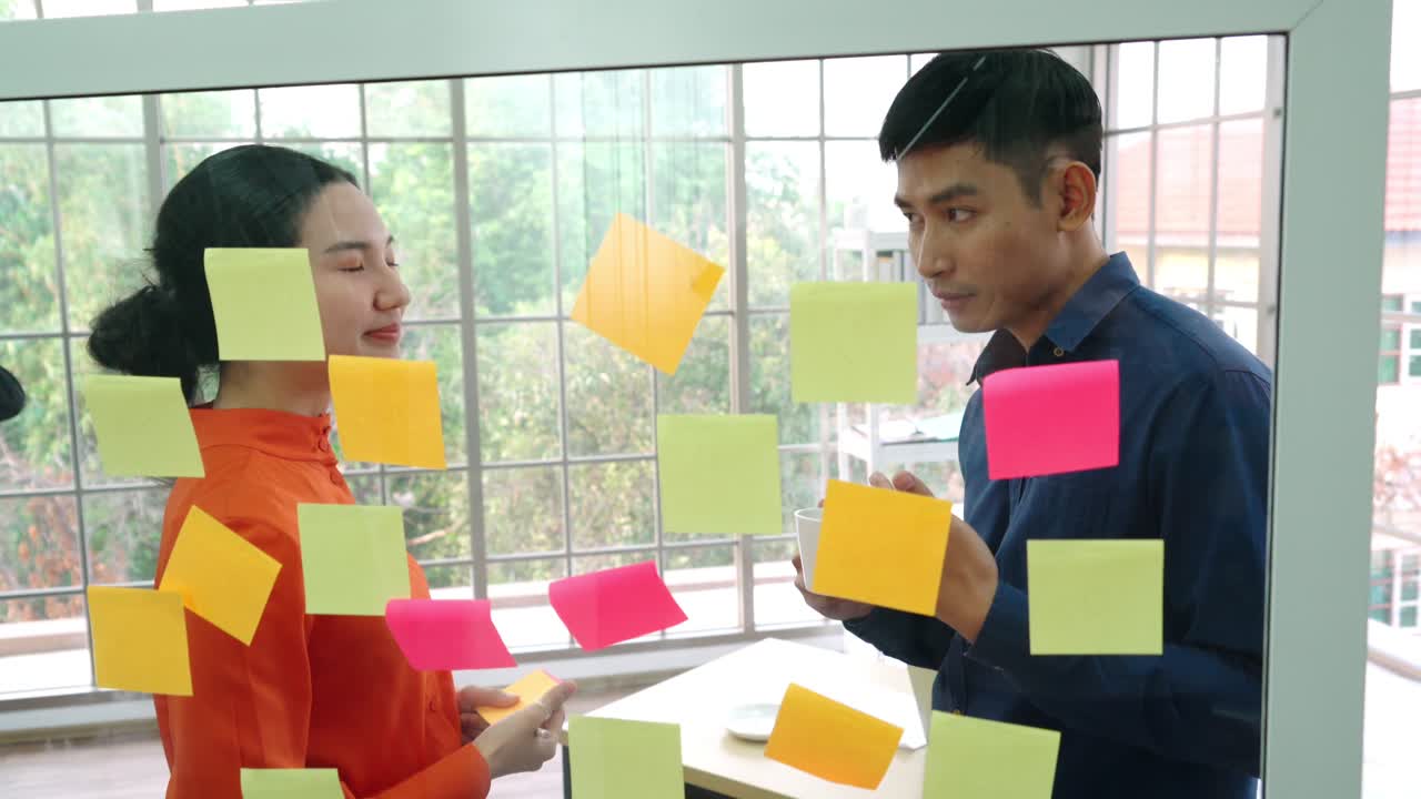 Business people work on project planning board