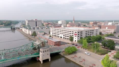 Downtown-Joliet,-Illinois-along-the-Des-Plaines-River-with-drone-video-moving-up-close-up