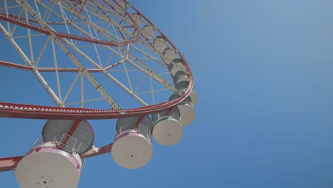 low angle view of ferris wheel. clear sky in the background. sunny day. amusement park concept.
