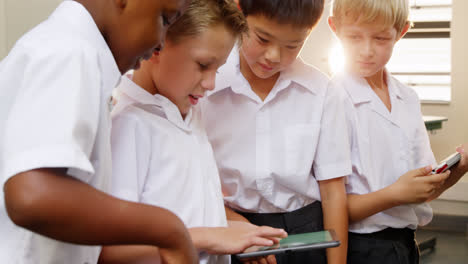 school kids using digital tablet in classroom