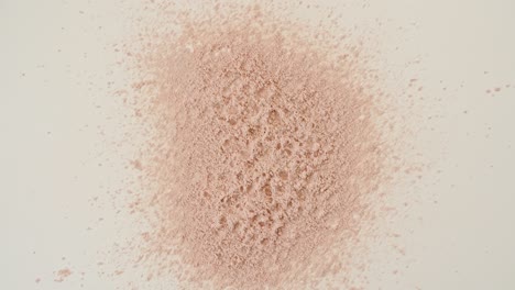 powder, particles of cosmetics fall on the table. animation of sand.