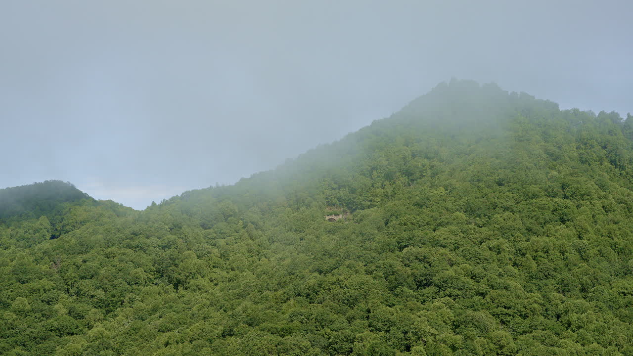 Drone shot soaring toward misty Appalachian mountains