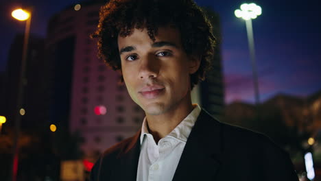 Smiling-man-looking-camera-night-business-district-closeup.-Businessman-posing