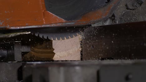 high speed shot of a circular saw stopping while cutting a piece of wood