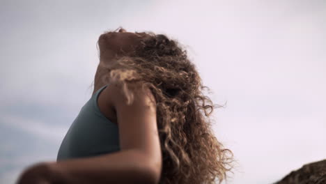 Feeling-oneself-breathing-while-meditating-curly-woman