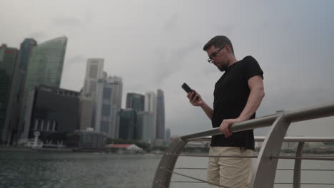 man using smartphone in singapore city