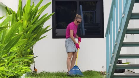 woman sweeping a lawn