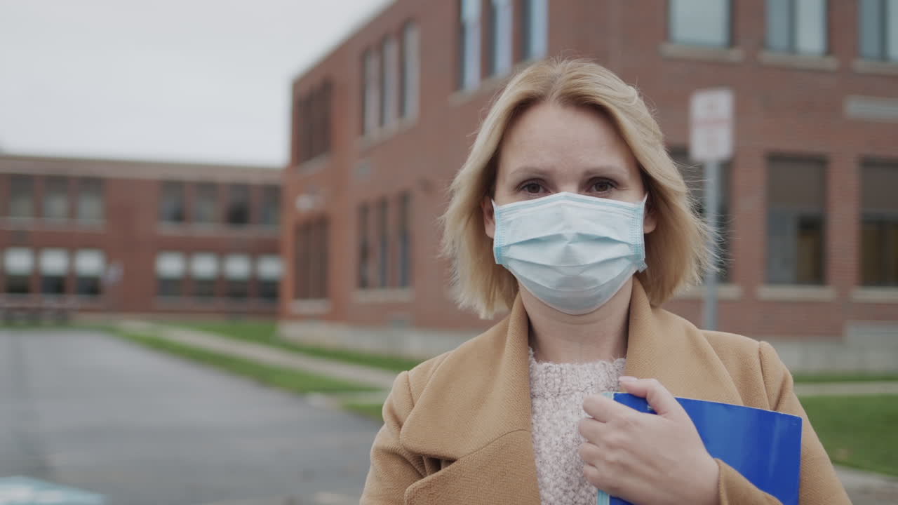 Portrait of a female teacher in a protective mask.