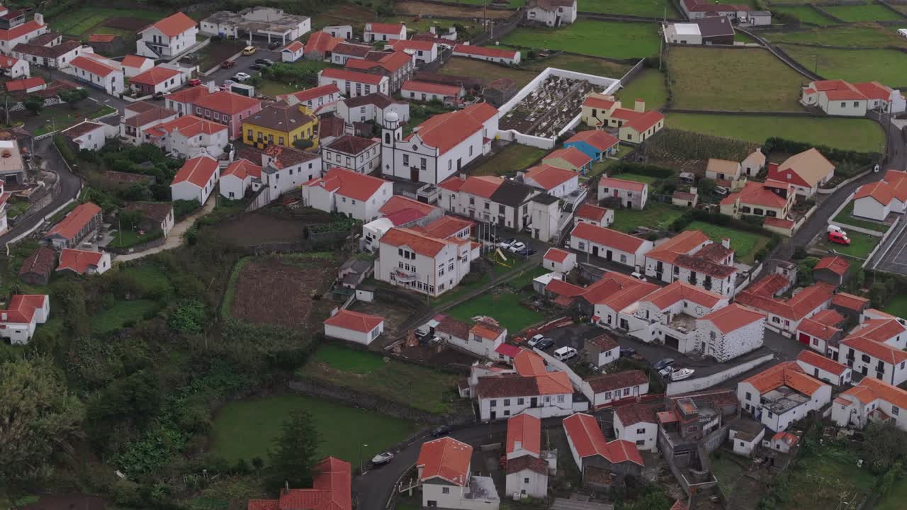 Drone shot tilting away from Faj&atilde; Grande at Flores Azores at sunset