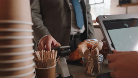 close up customer making contactless payment using smartphone mobile money transfer man buying coffee in cafe enjoying service at restaurant