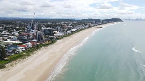 City-Landscape-At-The-Waterfront-With-Rocky-Groyne-In-Palm-Beach,-Queensland,-Australia