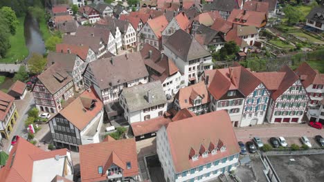 Aerial-ascending-shot-over-a-historic-german-village-with-traditional-and-half-timbered-houses