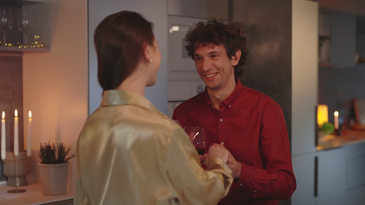 Couple sharing a romantic evening with wine in the kitchen